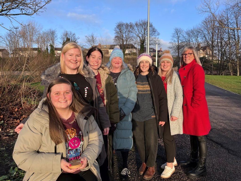 The Health Improvement Team with Morgan McKay, Health Walk Coordinator, holding the Paths for All Walk at Work Award