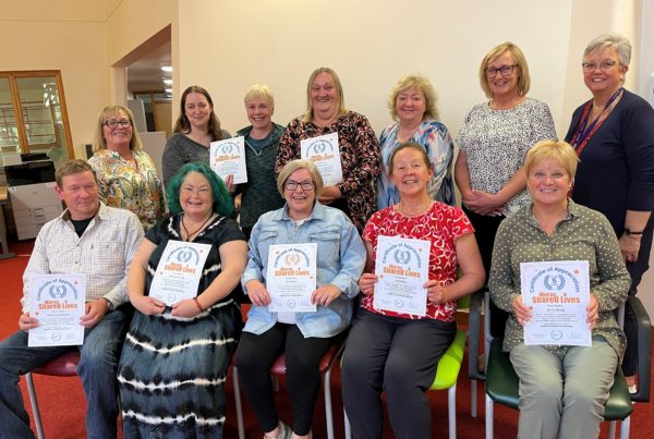 A group of Shared Lives carers proudly show off their certificates of appreciation.