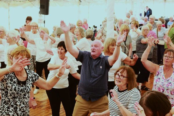 A joyful crowd celebrates the 20th anniversary of the BALL groups in Moray.